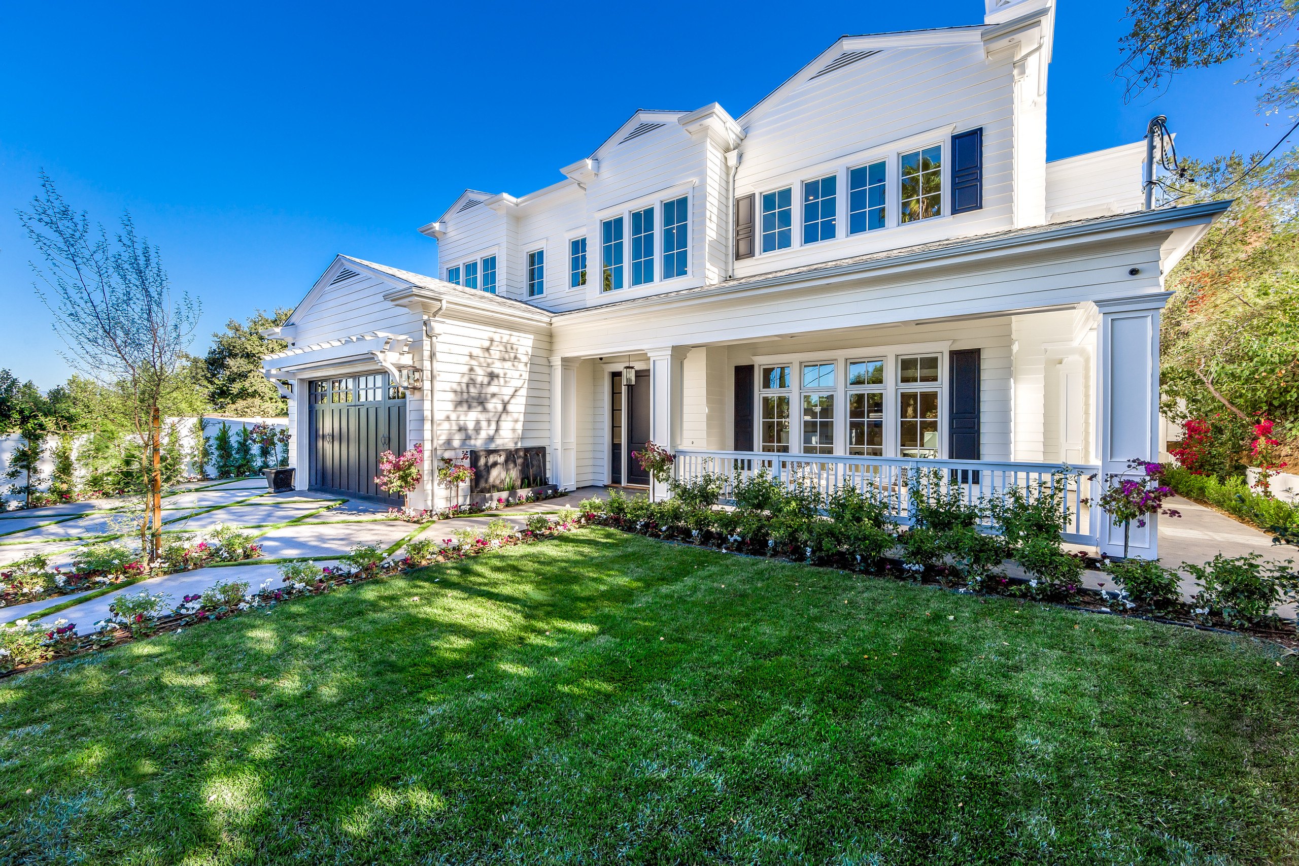 The front elevation of the Encino estate with its lawn and drive.