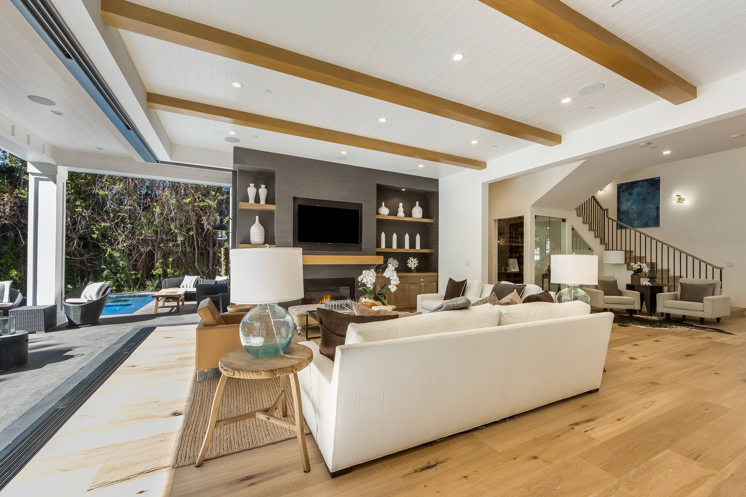 The family room of the Encino farmhouse with its wall slid open to the terrace.