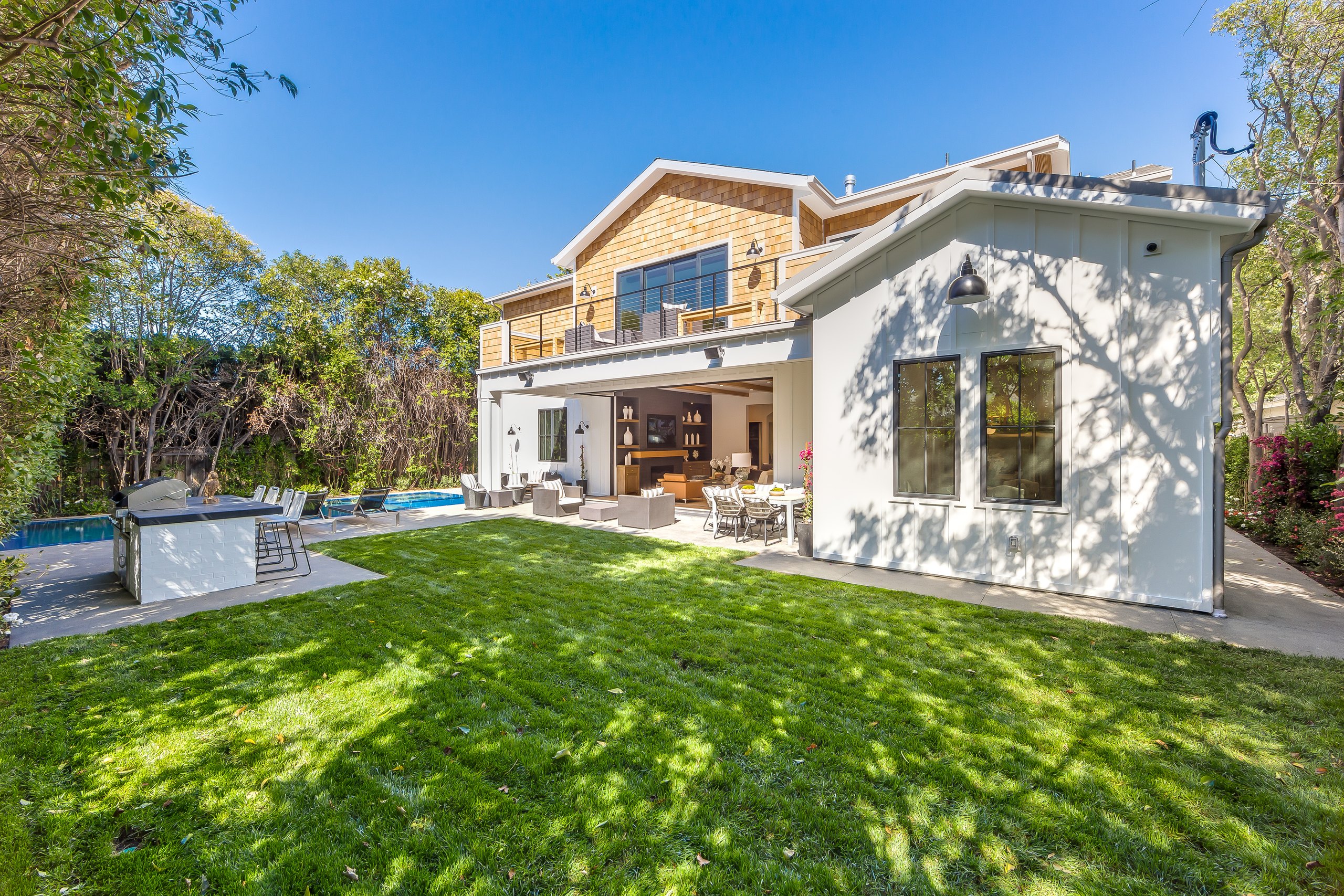 The Encino farmhouse from the garden with the pool in the foreground.
