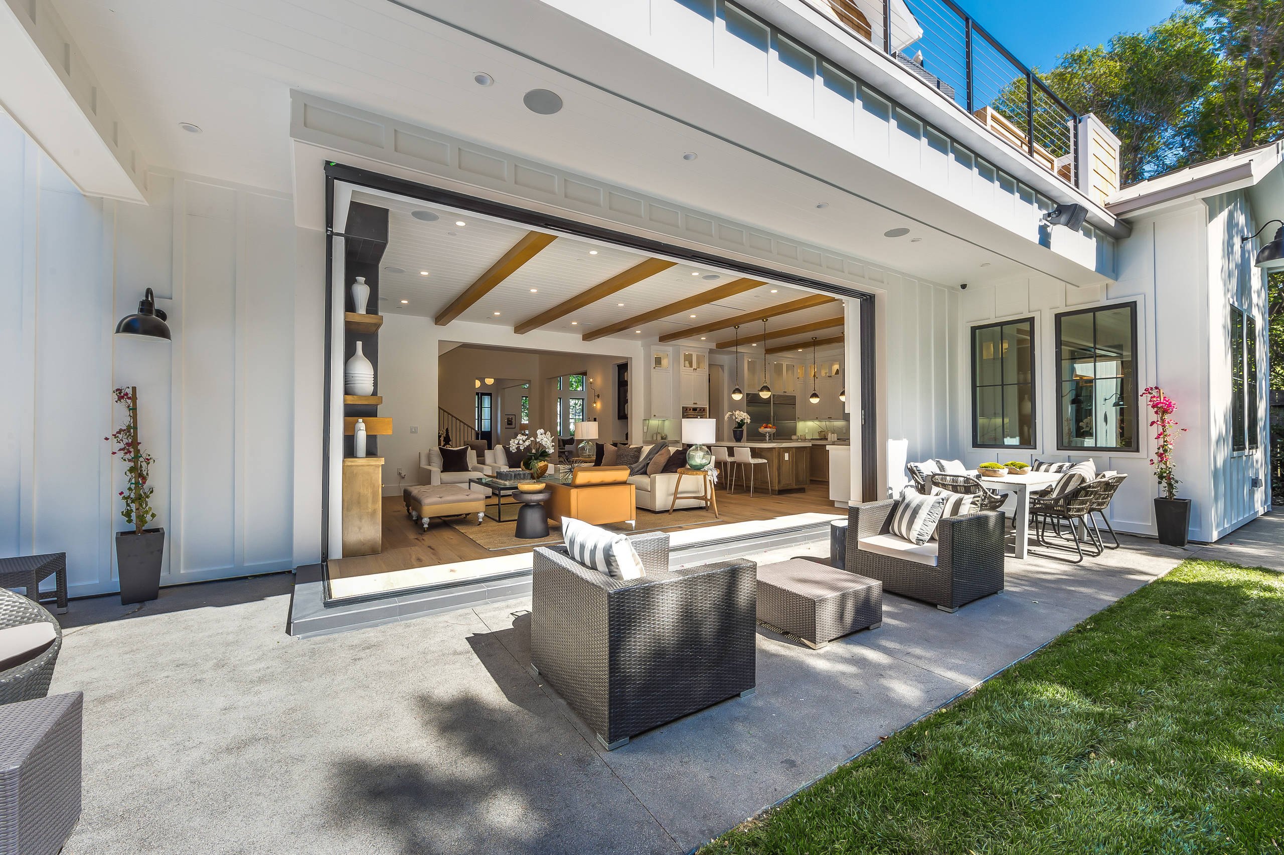 The covered patio of the Encino farmhouse looking into the family room.