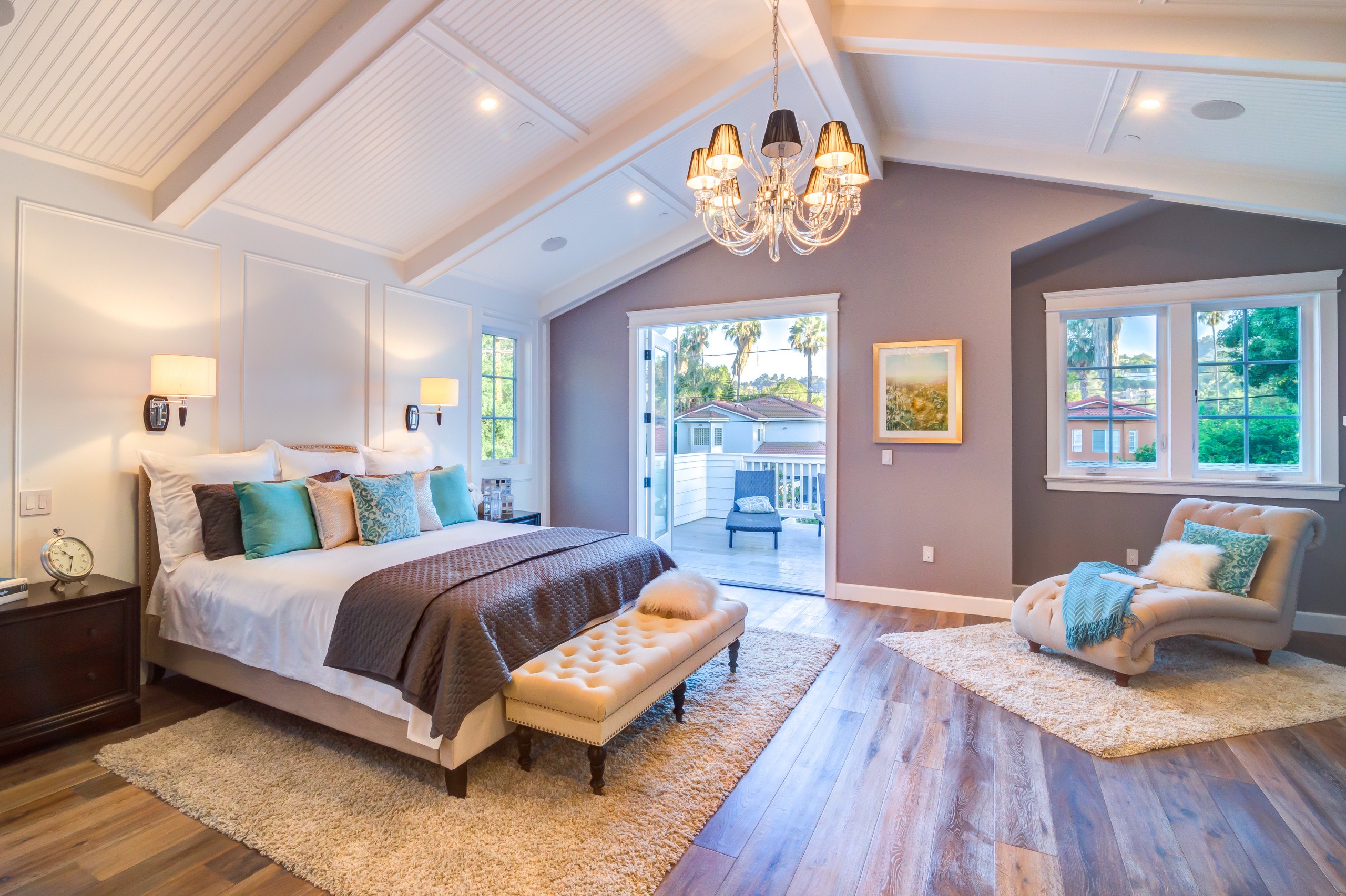 A vaulted upper-floor bedroom in the Studio City residence with a window seat and garden light.