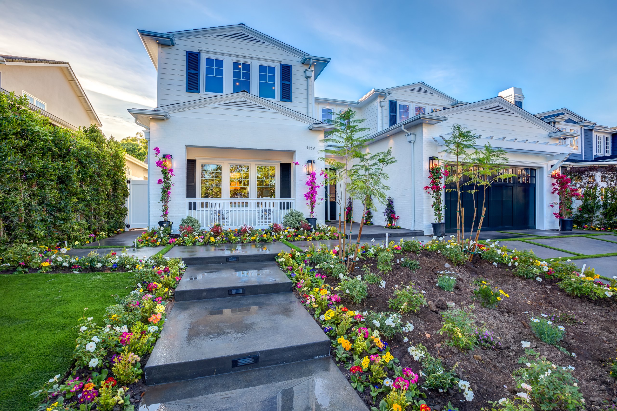 A two-storey Studio City residence at twilight, its windows lit against a deep blue sky.